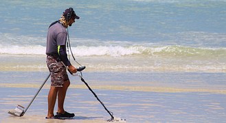 man using Metal Detector